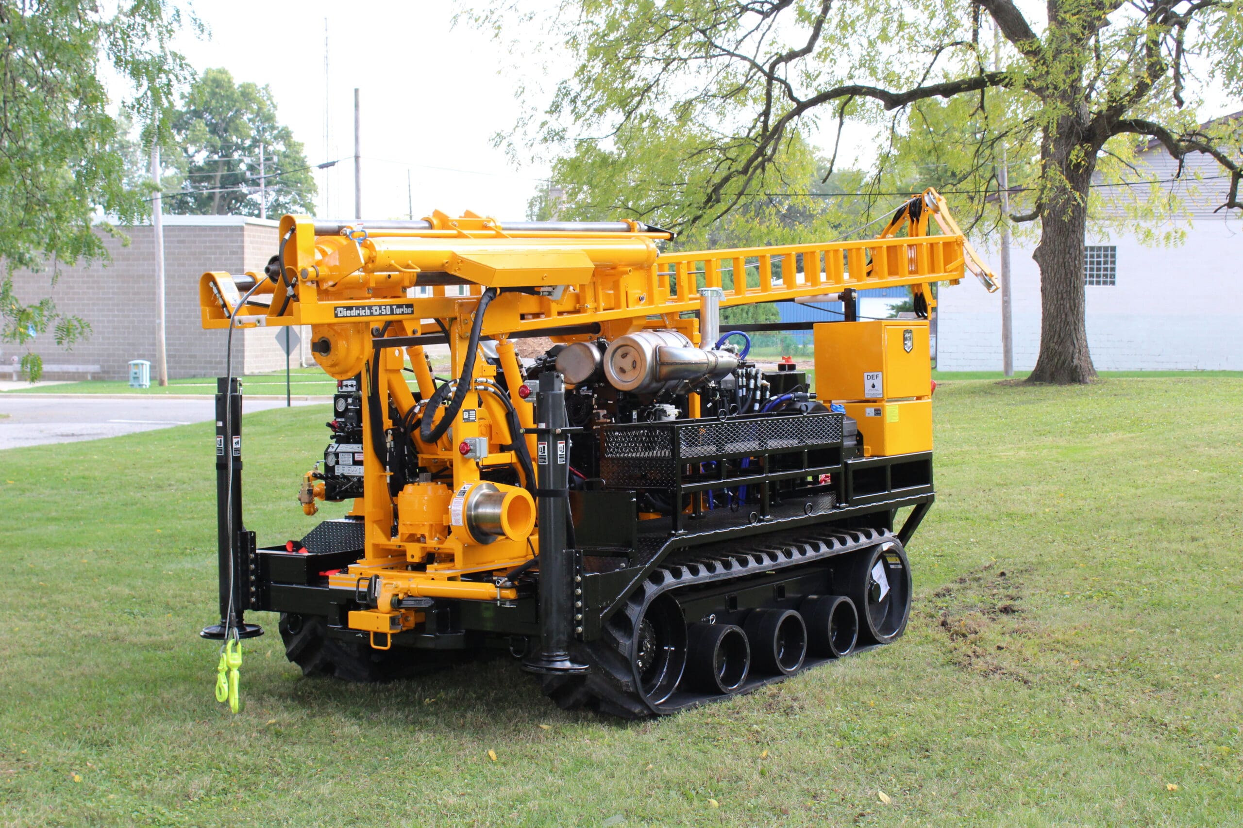 Diedrich D50 Turbo track-mounted drill rig on grass, featuring mechanical drilling system for geotechnical and environmental drilling projects.