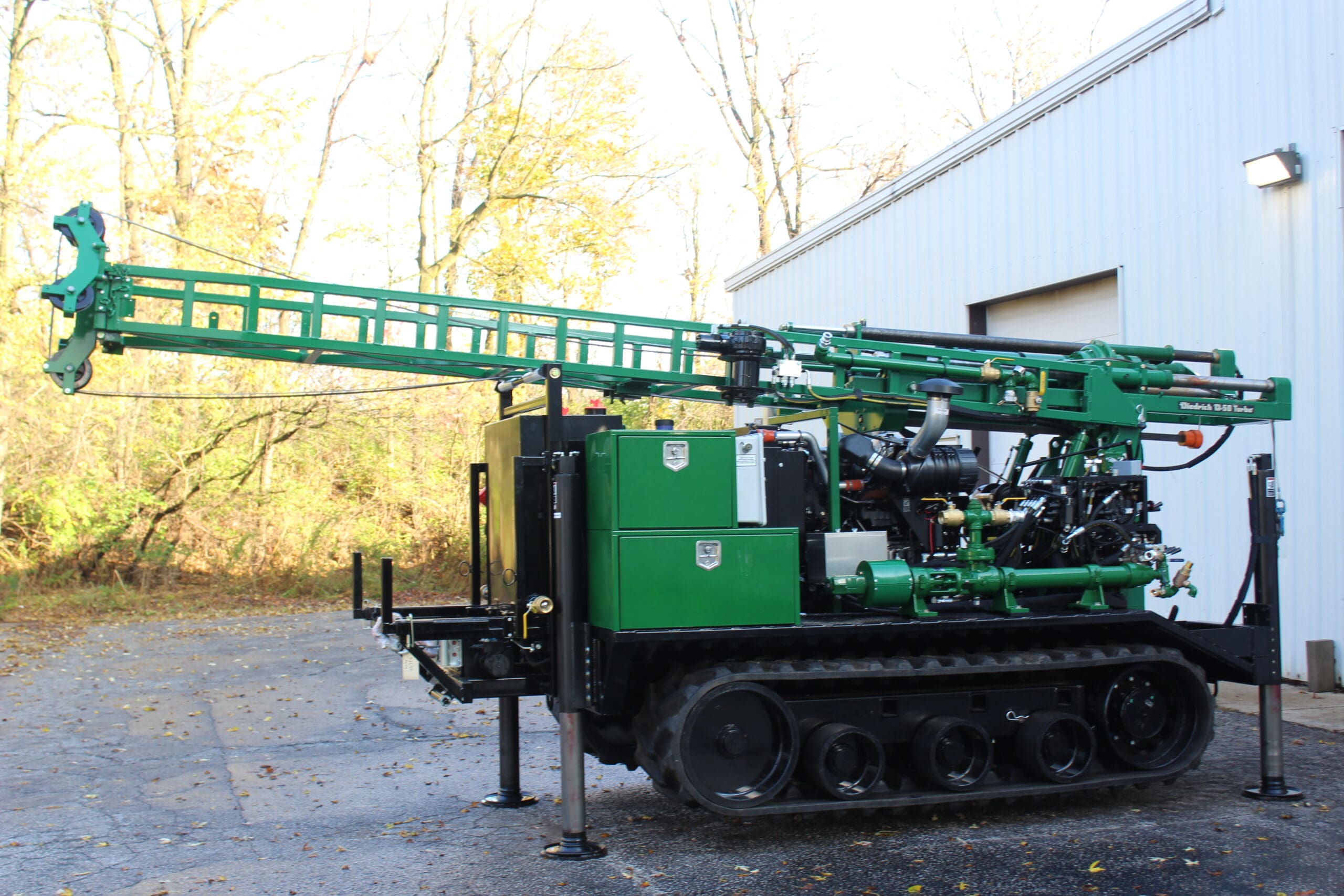 Green D50 Diedrich Drill track-mounted rig with extended mast, designed for soil boring, auger drilling, and subsurface investigation.
