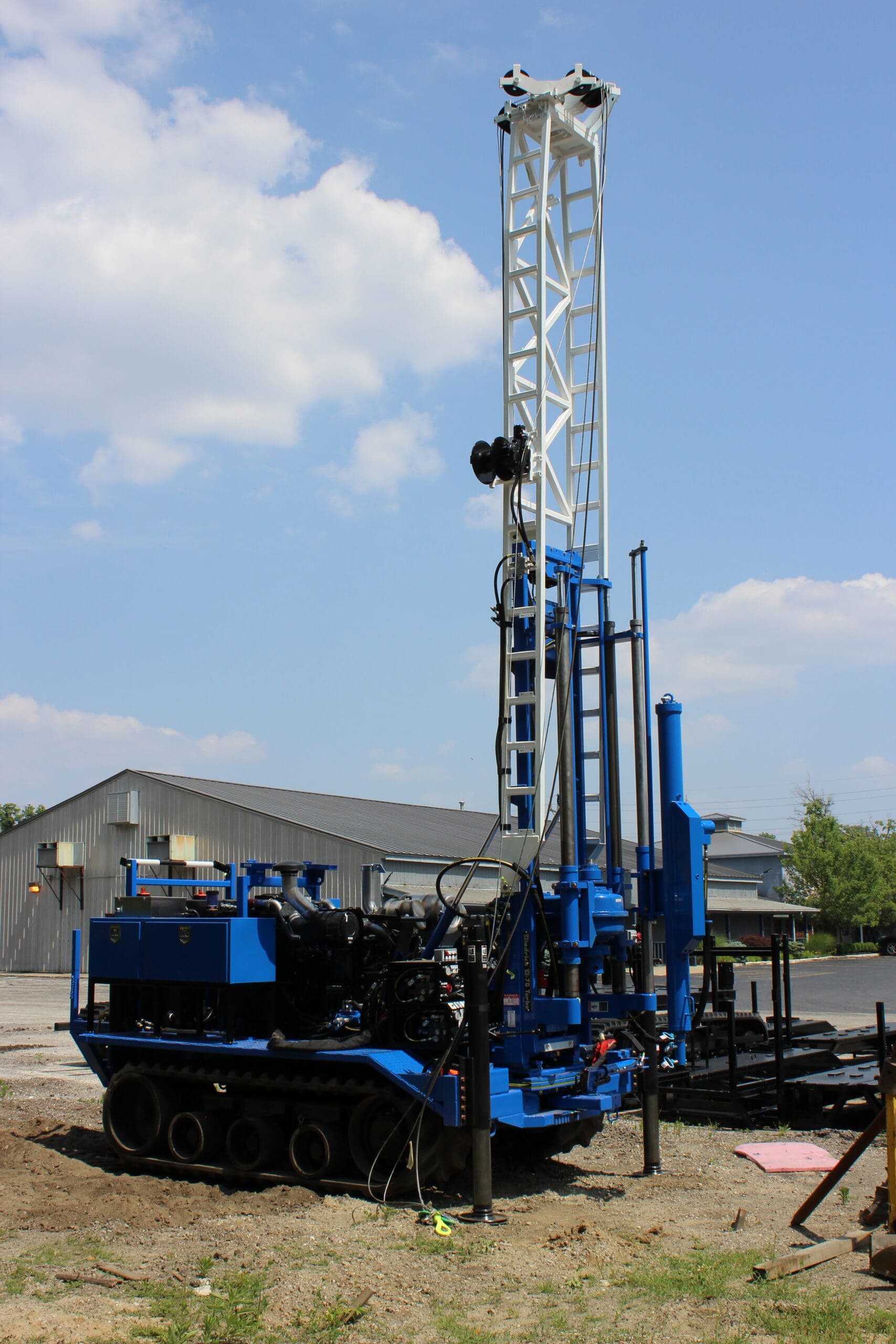 D70 Diedrich Drill rig mast raised vertically on track-mounted drilling machine, showing components used for geotechnical and environmental drilling.
