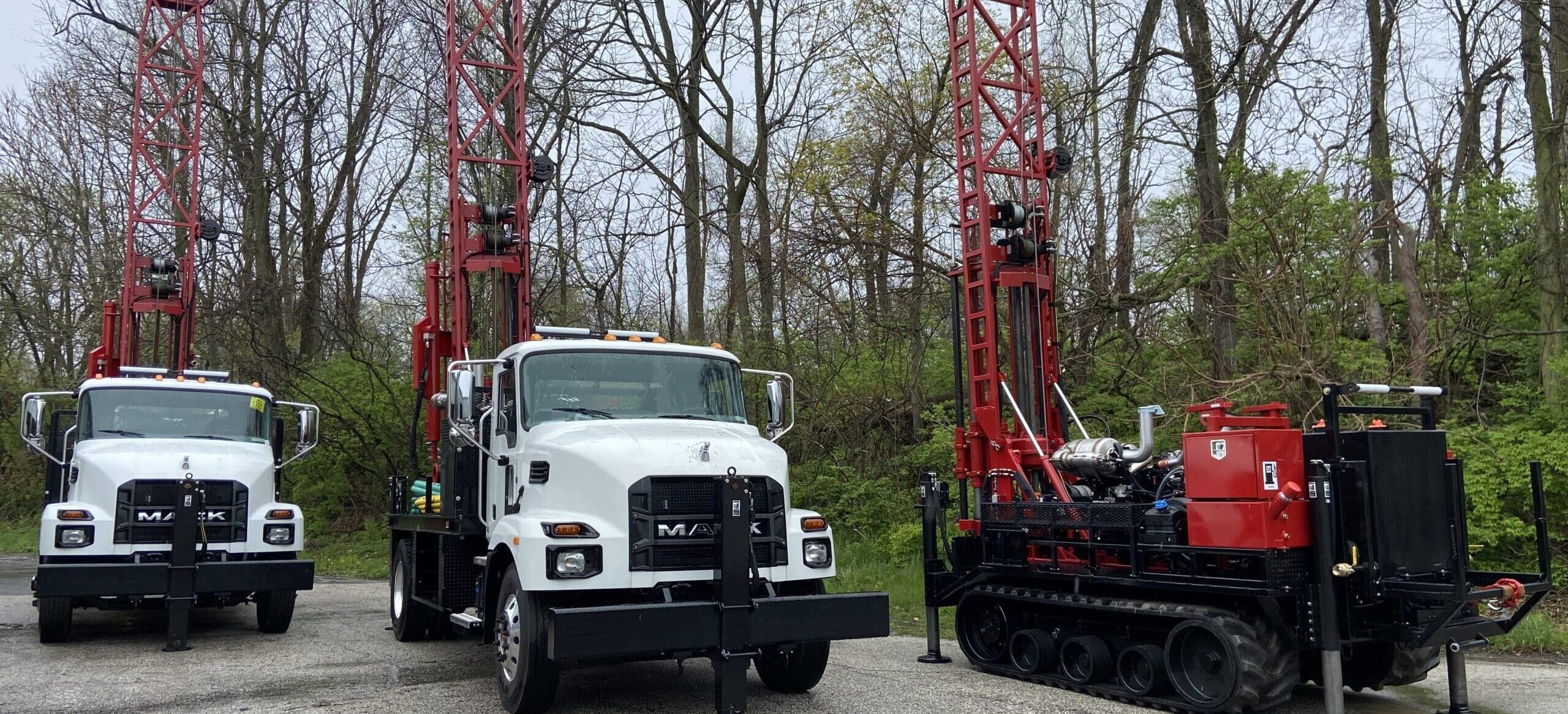 Fleet of Diedrich Drill rigs including truck-mounted and track-mounted geotechnical drilling equipment ready for field deployment.